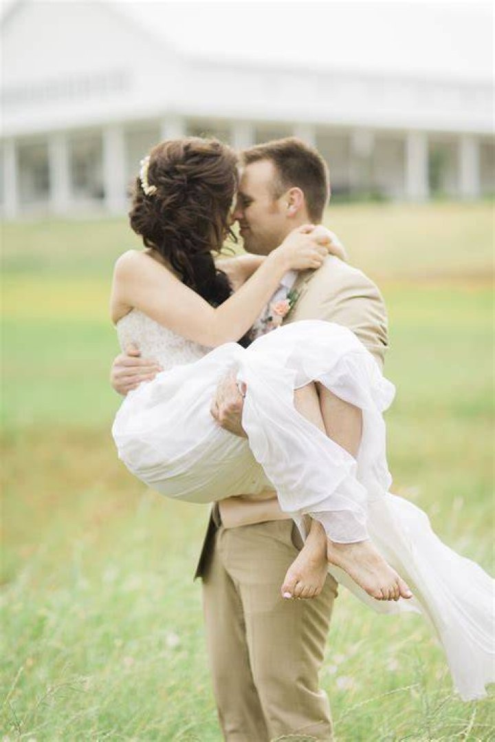 a barefoot bride in a white simone rocha tea length gown