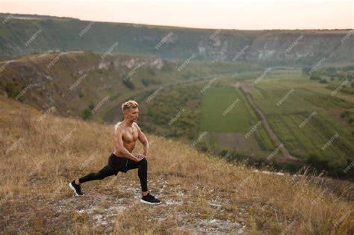 a man lunging with a barbell over his shoulders wearing a pair of barefoot shoes