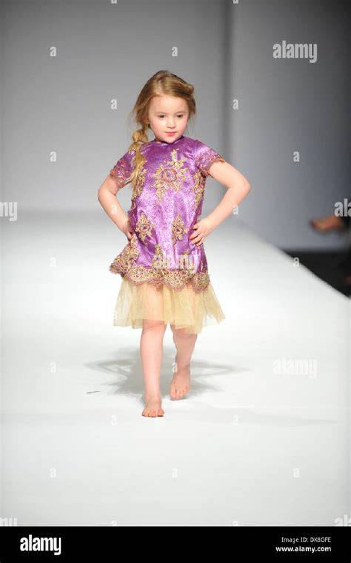 a model walks the runway at the garment in copenhagen wearing a handkerchief top and layered midi skirt