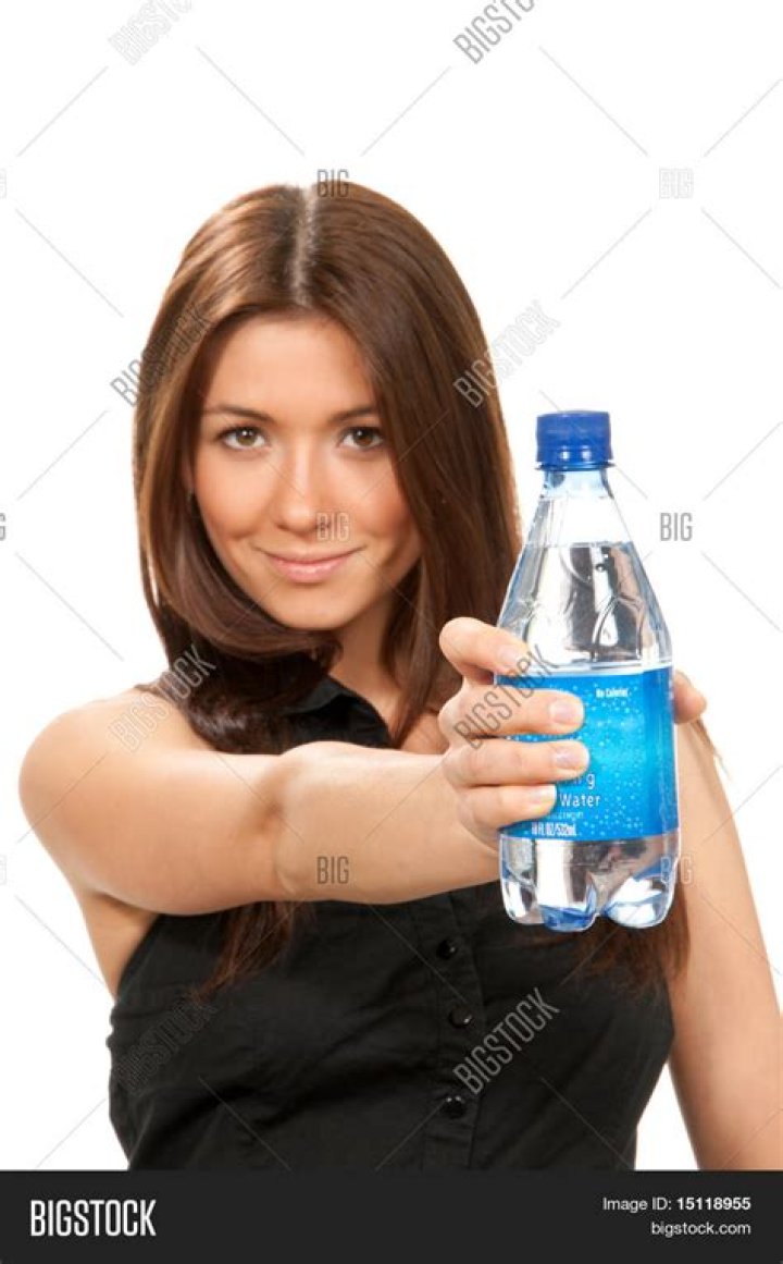 A woman holding a bottle of dish detergent in her hand