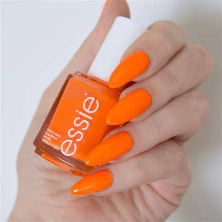 An orange tube of essie on a roll apricot cuticle oil, best cuticle oils