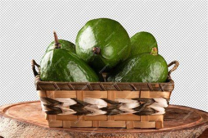 avocado fruit in a basket non a wooden background