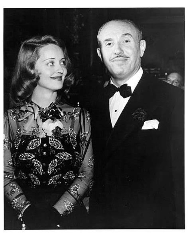 Bette Davis and Jack Warner at the 1936 Oscars, holding Davis's Oscar for Best Actress in a Leading Role for her role in the film 'Dangerous'.