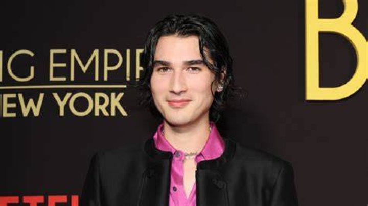 blake abbie wears a black jacket, white button down shirt, and black pants with full length zippers down the front at a lunar new year party in 2023