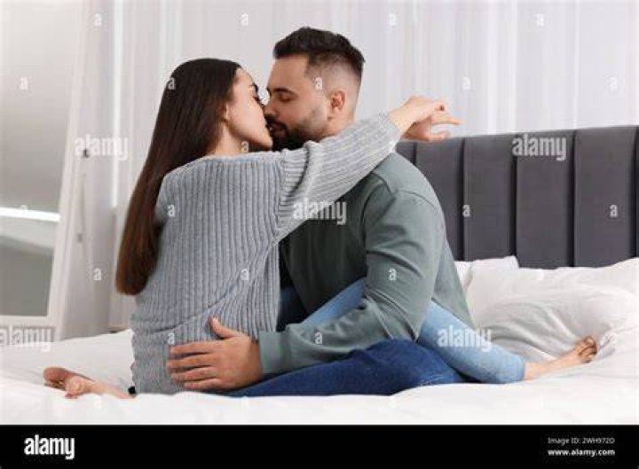 couple kissing in the bedroom