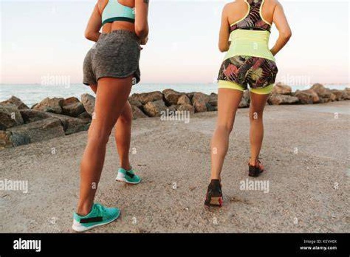 cropped view of two women doing calf raises