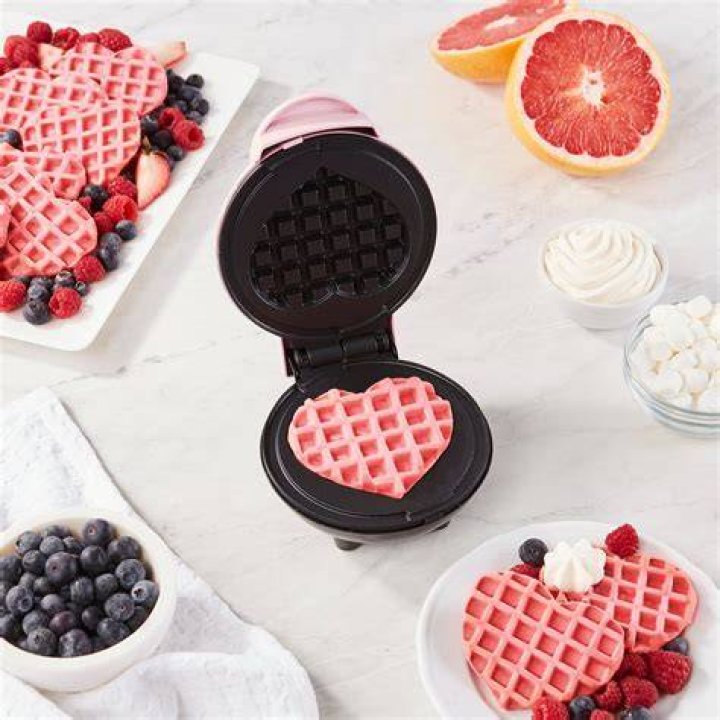 dash heart shaped waffles maker on a plate