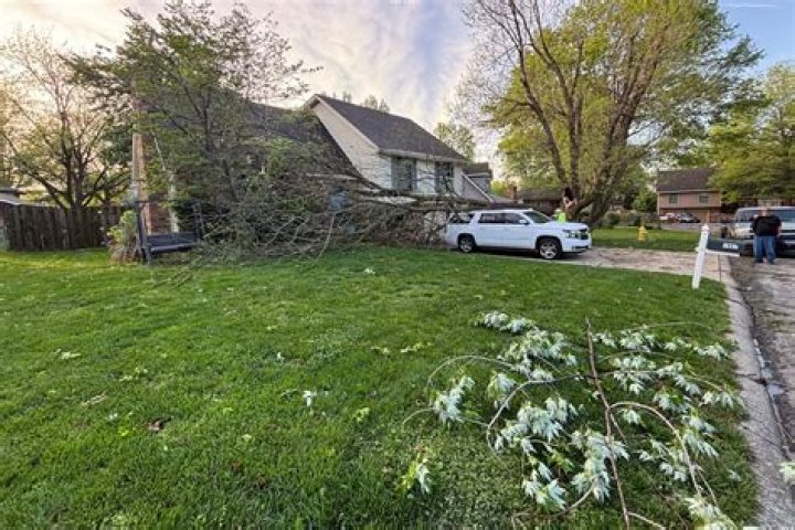 Debris litters the lawn of a severely damaged home following the tornado. Photo / AP