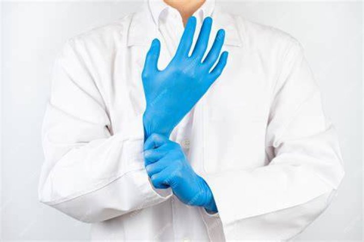 doctor wearing blue latex gloves