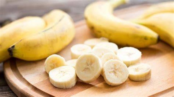 fresh bananas and bananas cut into pieces in a bowl for health on the table
