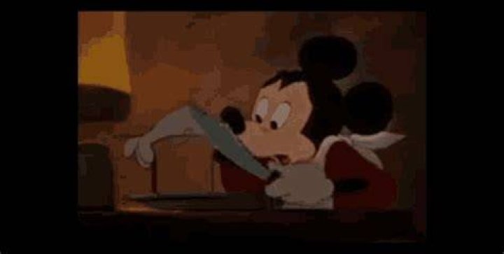 GIF of Mickey mouse cutting a very thin slice of bread