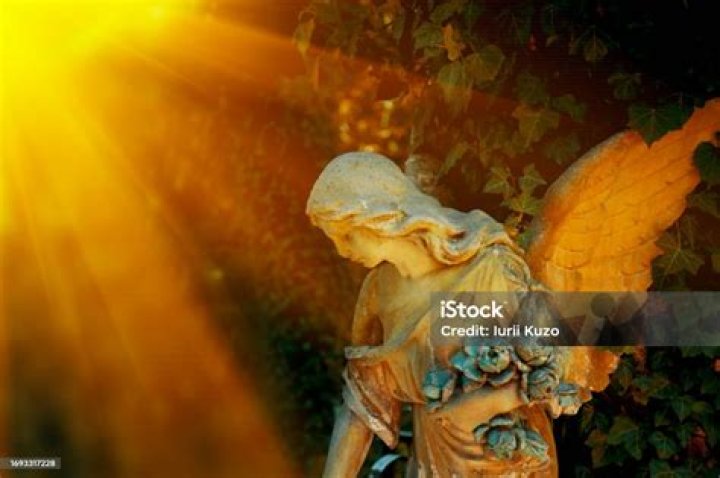Guardian angel statue in sunlight Guardian angel statue in sunlight