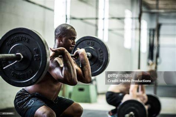 gym men doing front squats