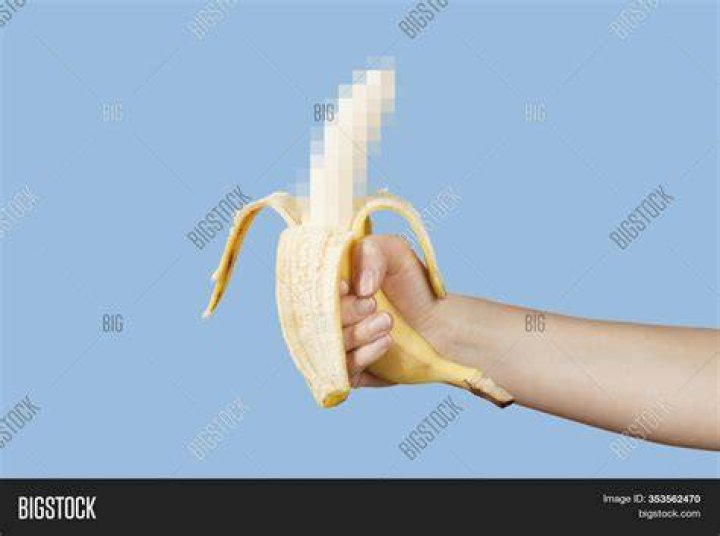 hidden censored banana in hand on a blue background horny aroused penis, male erection and sexual education funny pornography