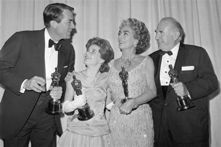 Joan Crawford (accepting for Anne Bancroft) with Gregory Peck, Patty Duke And Ed Begley with their Oscars, at the 35th Academy Awards.