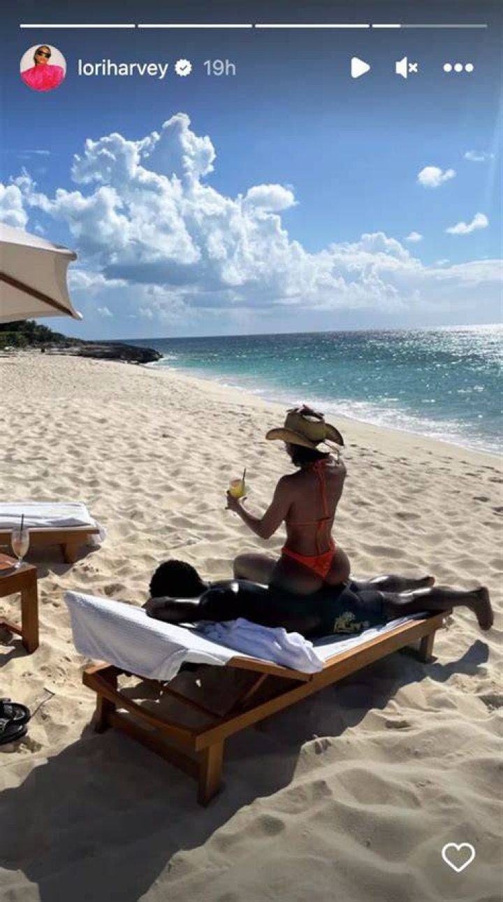 Lori Harvey Sits on Her Boyfriend’s Back and Drinks a Cocktail During Beach Day