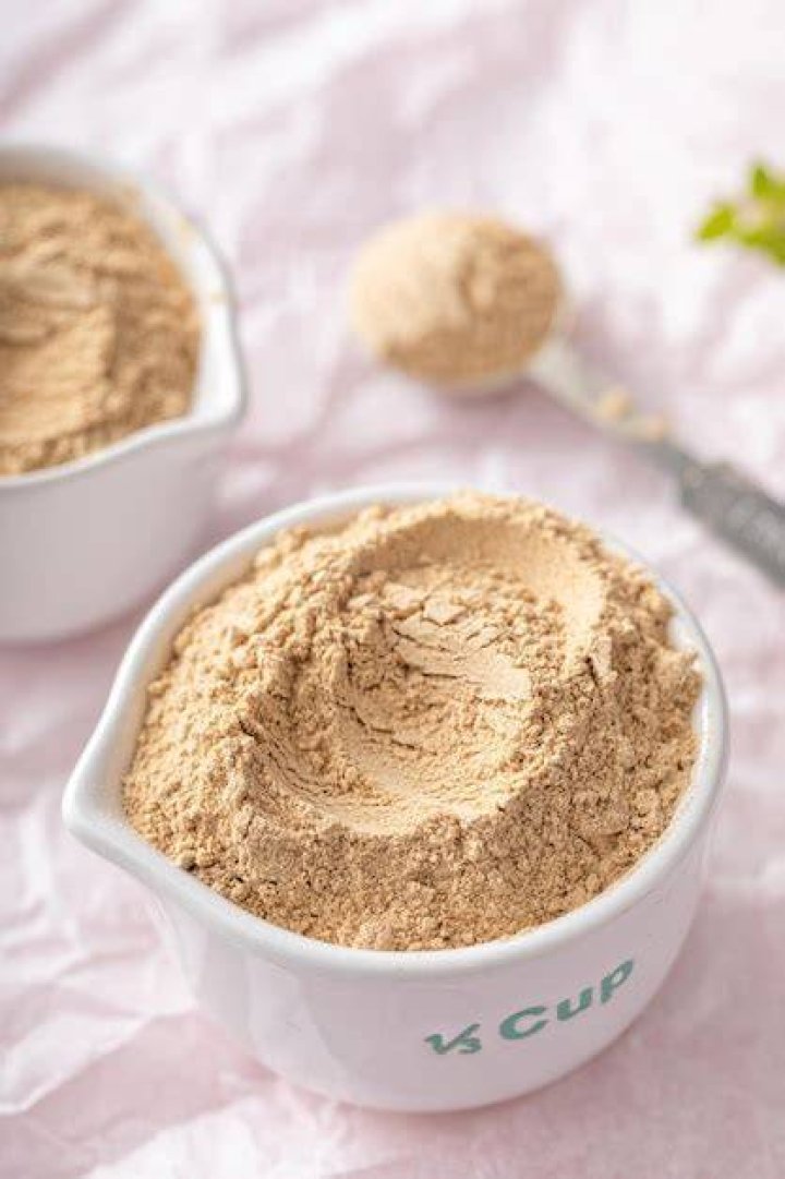 maca powder in measuring cups and a spoon, food supplement
