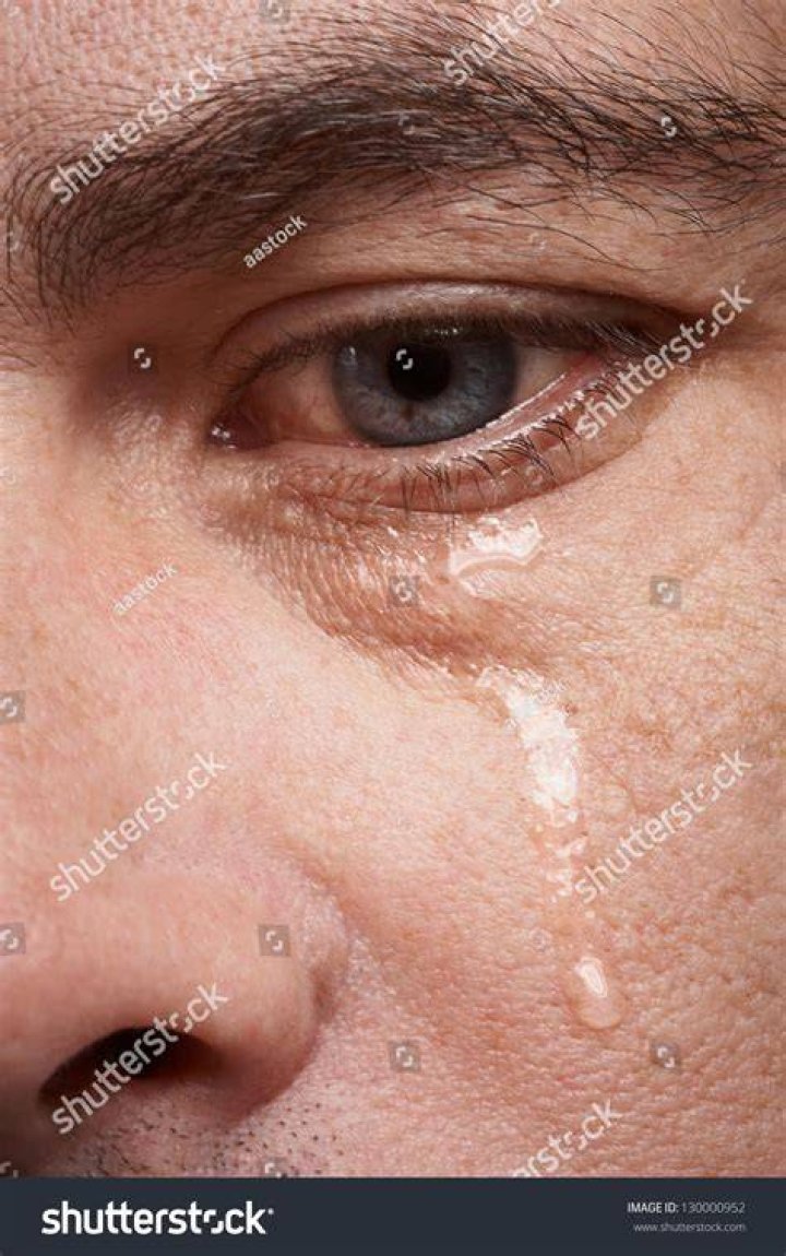 Man crying, close-up of eye and tear