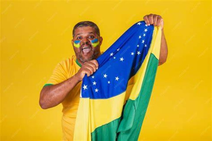 Man raising the Brazilian flag
