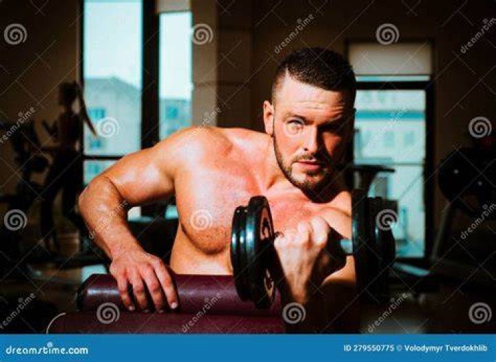 man training with dumbbells