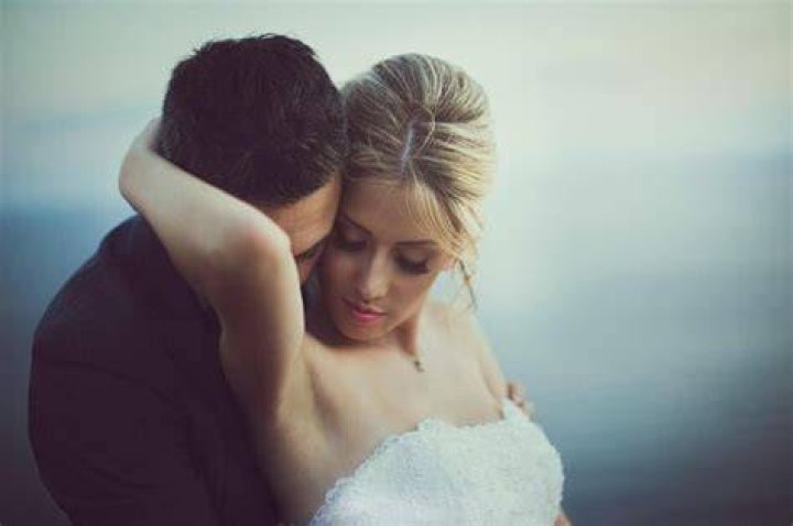 midsection of couple kissing