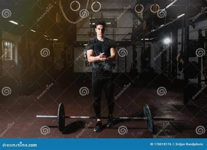 Muscular guy on cross training - weightlifting and squats