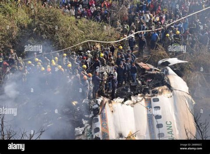 Nepalese rescue workers and civilians gather around the wreckage of a passenger plane that crashed in Pokhara, Nepal Photo / Krishna Mani Baral, AP