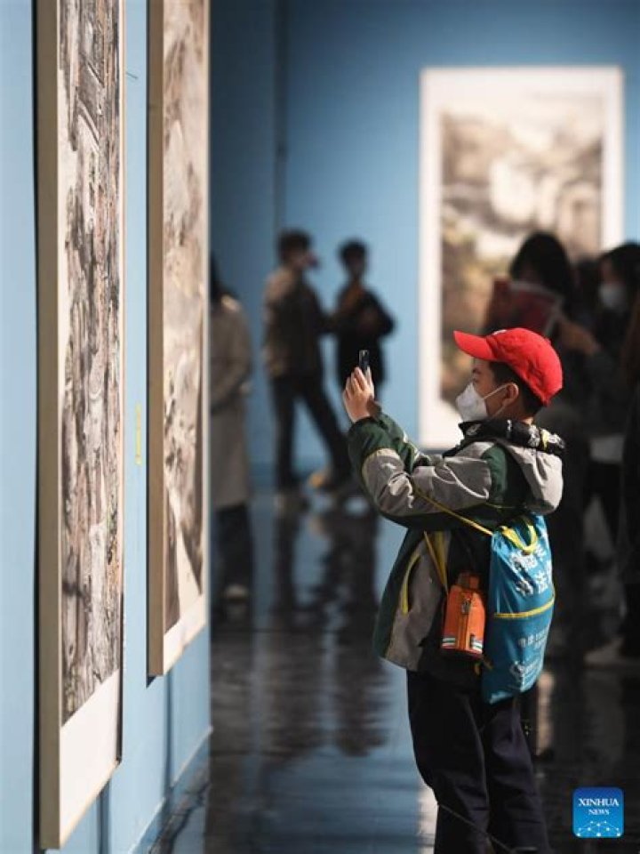 People visit the new artwork in Irpin, Kyiv, supposedly by British street artist Banksy. Photo / Andrew Kravchenko, AP 