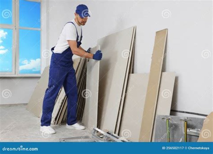 Person carrying lightweight drywall | Construction Pro Tips