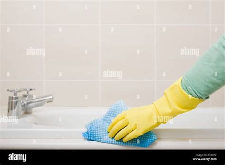 Person cleaning bath