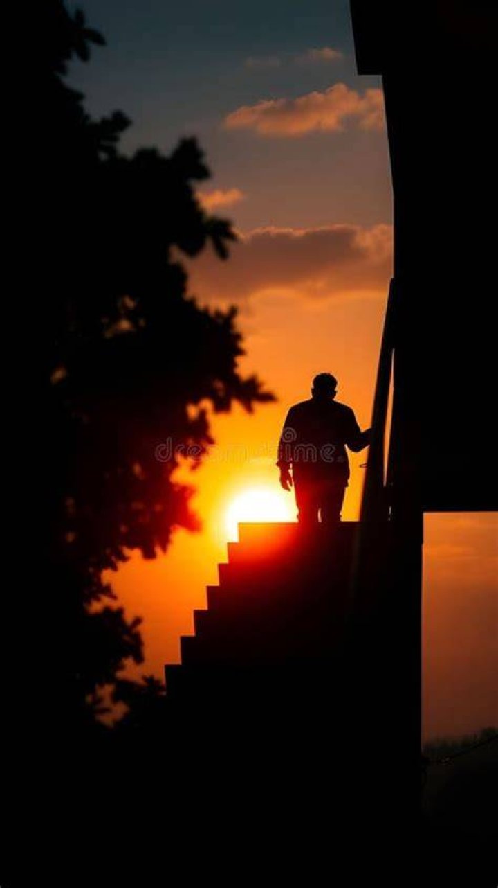 person descending flight of stairs while looking at their phone