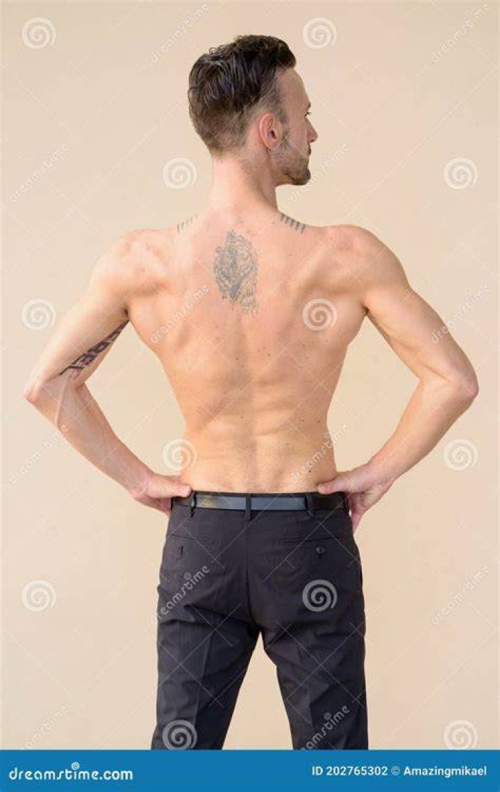 rear view of shirtless young mans back against the mediterranean sea, pe&ntilde;&iacute;scola, castell&oacute;n, spain