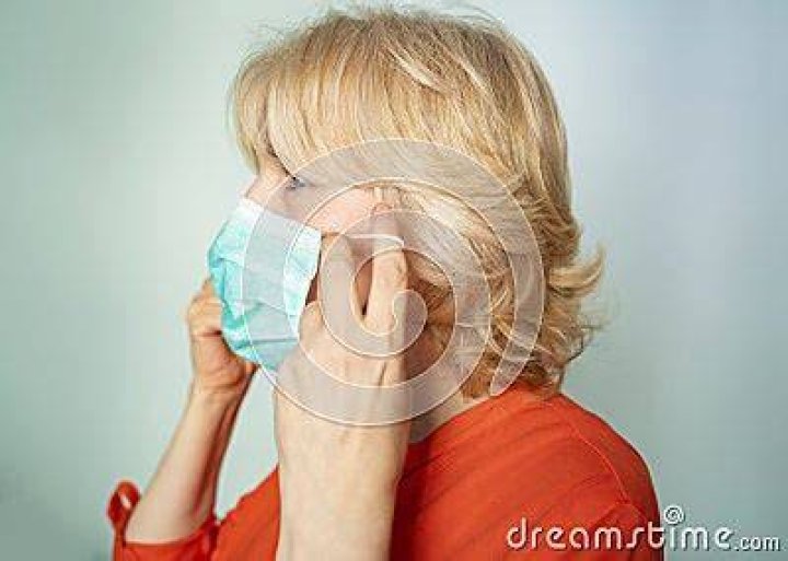 senior woman putting on surgical gloves