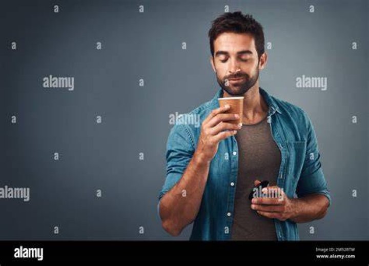 studio shot of man drinking protein shake