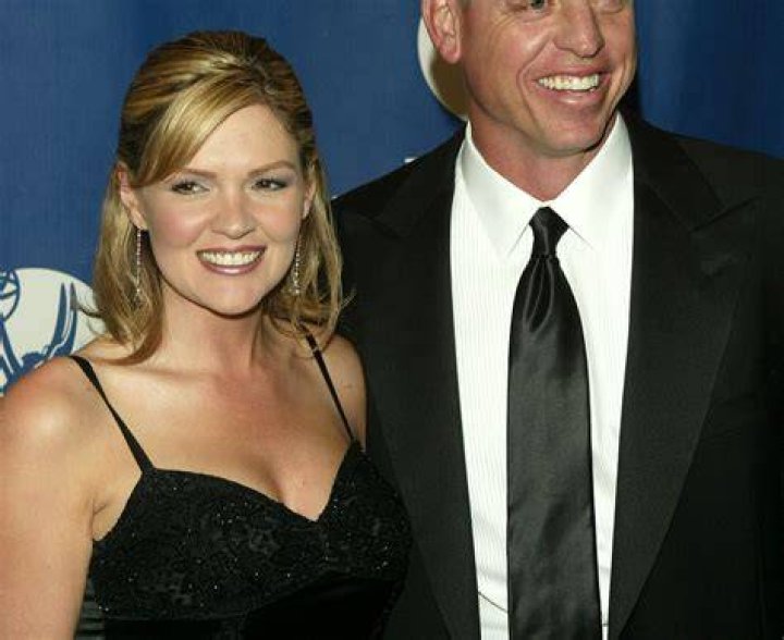 Troy Aikman and Rhonda Worthey posing outdoors together 