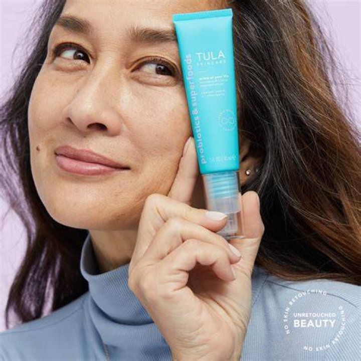 tula skincare smoothing and firming treatment primer with a swipe of product in the background