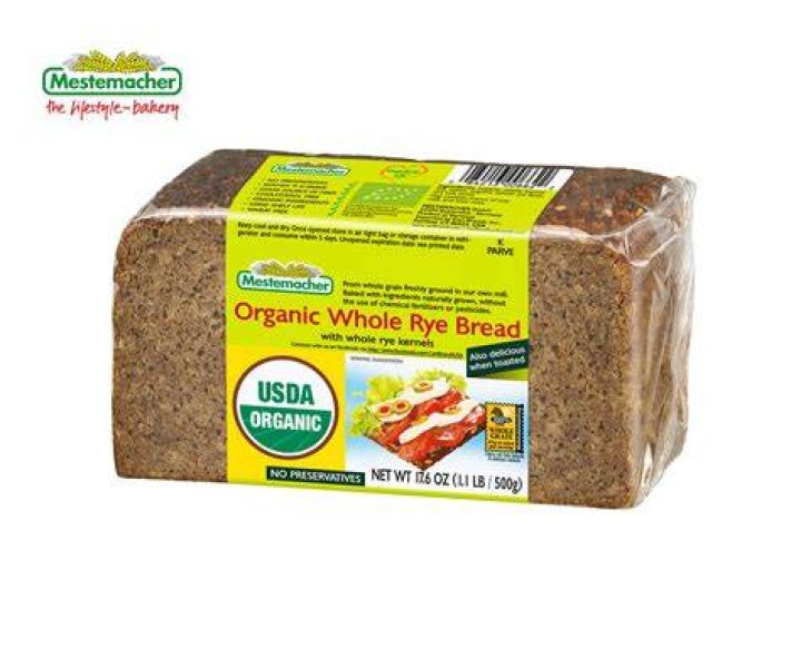 whole grain rye bread with seeds on blackboard closeup view, selective focus