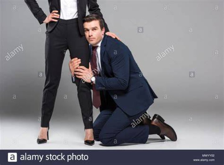 Young woman dominating young woman dominating a man with a whip